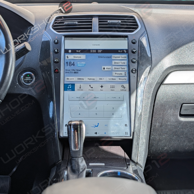 A large touchscreen car infotainment display installed in a vehicle dashboard, showing media and navigation interfaces. The screen is the main product focus, with the car interior around it.